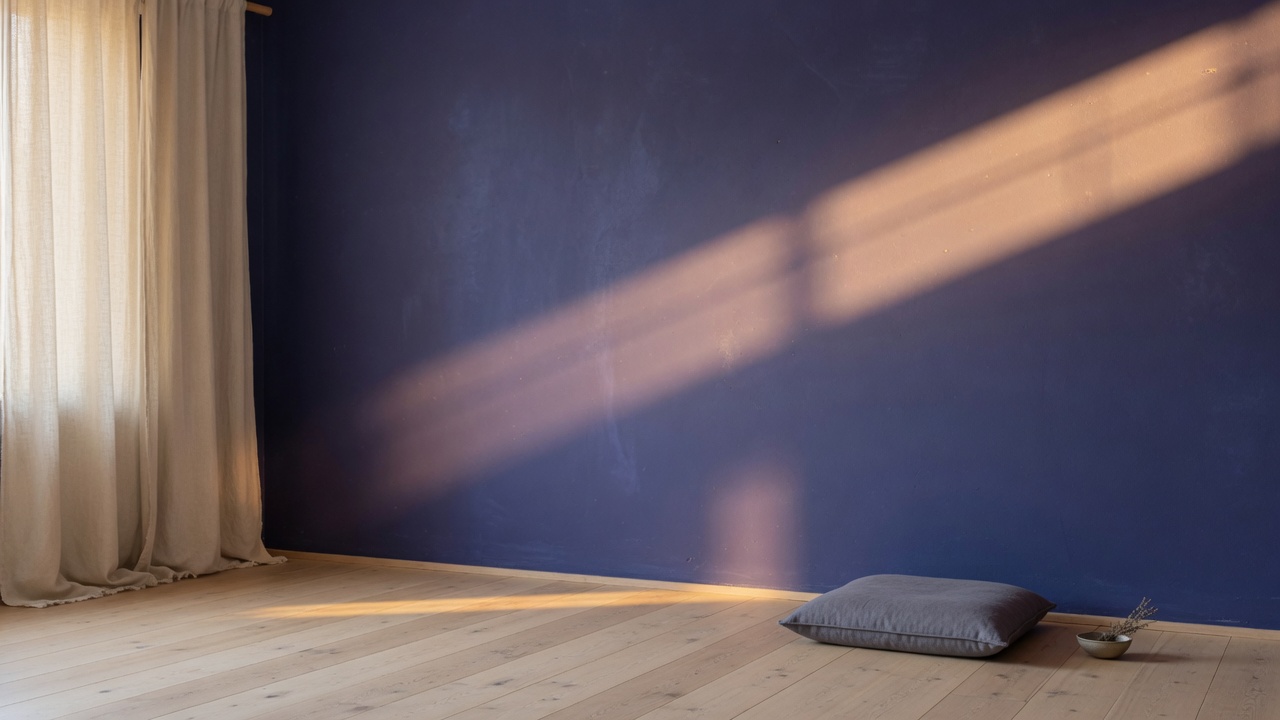 A quiet room with morning light across an indigo wall